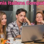 a group of people sitting at a table looking at a laptop compagnia italiana computer