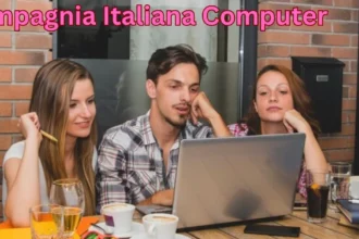 a group of people sitting at a table looking at a laptop compagnia italiana computer